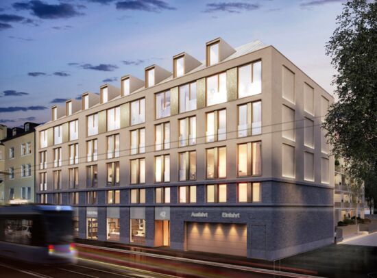 Evening view of Troger H&ouml;fe: Modern design, illuminated windows, and a tram.