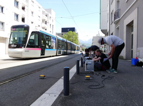 Getzner employees performing vibration analysis on tram tracks.