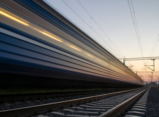 Fast train on tracks at sunset with blurred lights. Fast train on tracks at sunset with blurred lights.