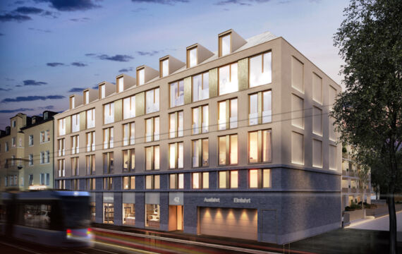 Facade of the Troger Höfe in Munich at dusk with a tram and light trails.